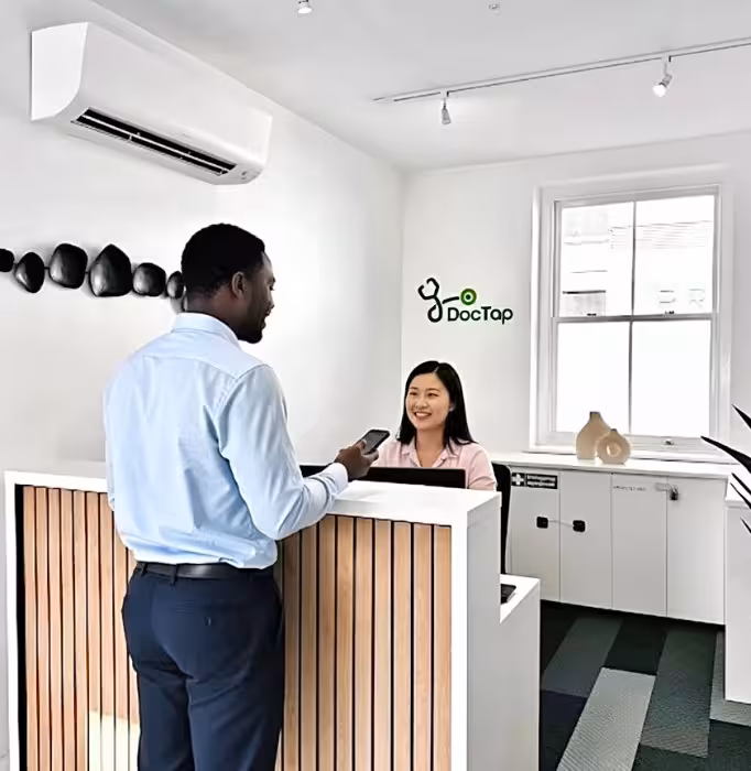 Patient checking in for their appointment at reception