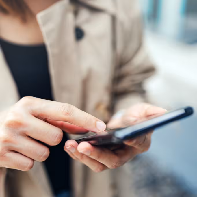 Woman using her phone to easily book a doctor's appointment with DocTap